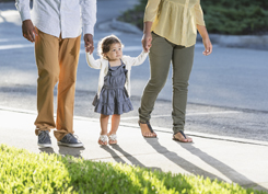 Hispanic toddler walking with parents