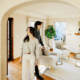 Smiling couple touring a home during a showing, representing today’s slower housing market where buyers have more time and options.