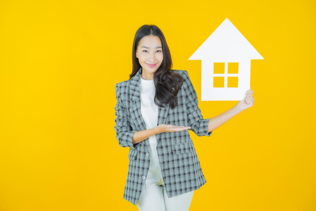 Portrait beautiful young asian woman with house or home paper si