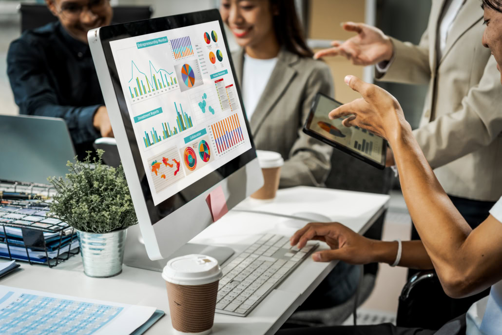 Asian colleagues meet at a desk, discussing business financial t